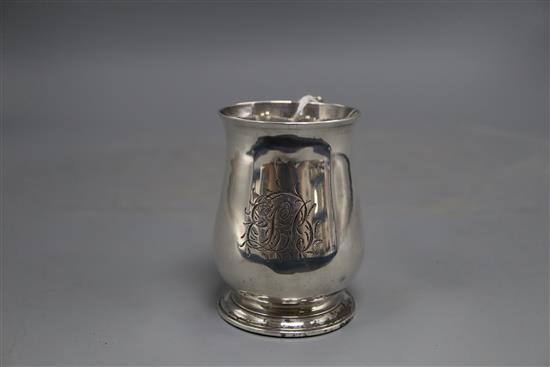 An early George III small silver baluster mug, with later engraved monogram, William Cripps, London, 1761, 9.3cm, 5.5 oz.